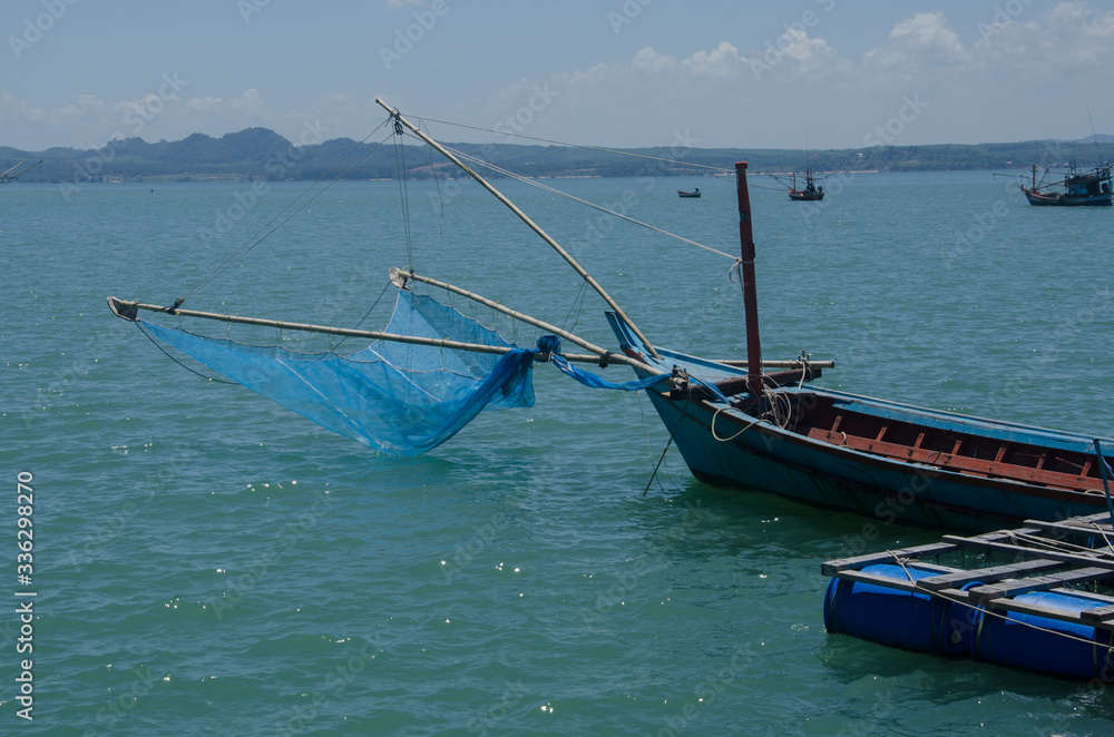 Fisherman boat with mesh in the sea