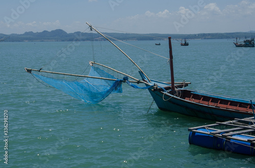 Fisherman boat with mesh in the sea