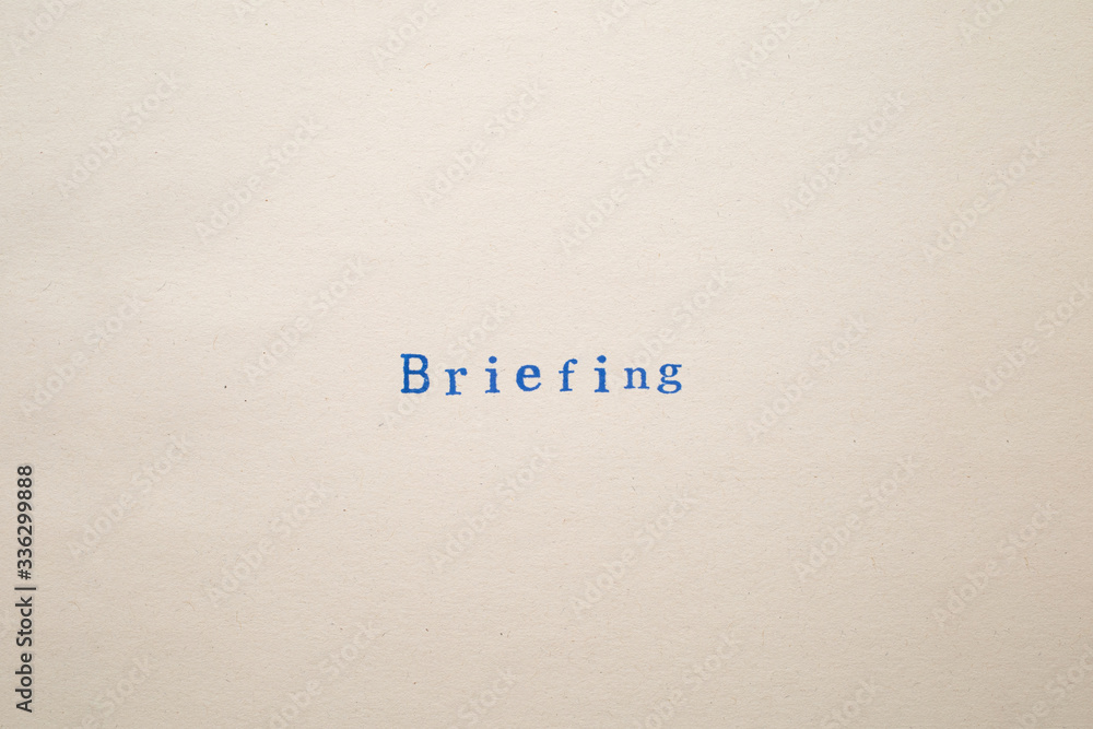 a BRIEFING word stamped on a piece of paper. a BRIEFING word stamped on a piece of paper.