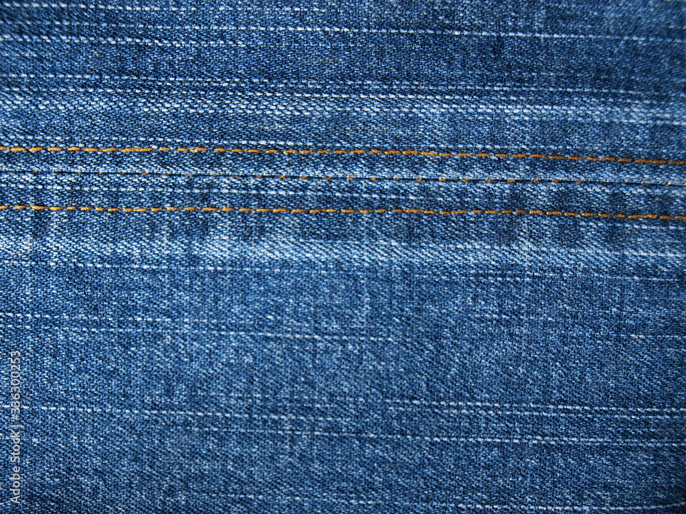 Close-up of jeans background with seams. Fabric backdrop with stitches Close-up of jeans background with seams. Fabric backdrop with stitches