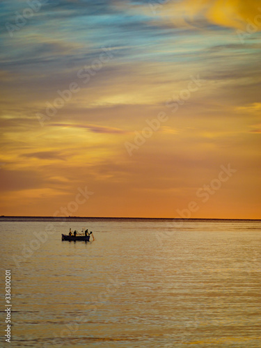 Boat on sea at sunrise. Morning seascape.