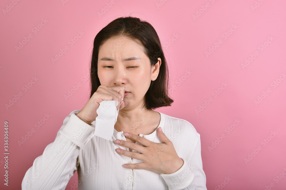 Asian woman have sore throat allergy and coughing, Sneezing and coughing in public place without