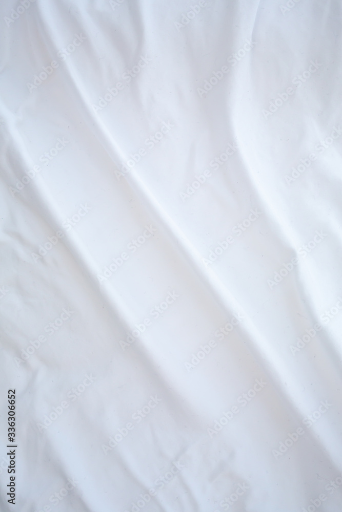 Obraz premium Blurred white bedsheet drying in the sun, Wrinkled texture, Abstract background, Close up shot, Selective focus, Housework, Laundry concept