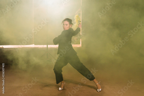 Pasadoble, latin solo dance and contemporary dance - Young beautiful female dancing into smoke cloud © satura_