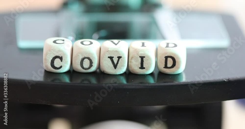 Close up of examining of test sample under the microscope in laboratory.