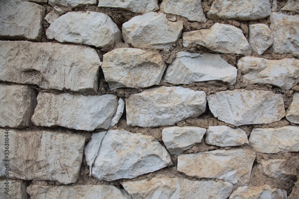 a wall made of stones. cobblestones with cement. masonry. construction
