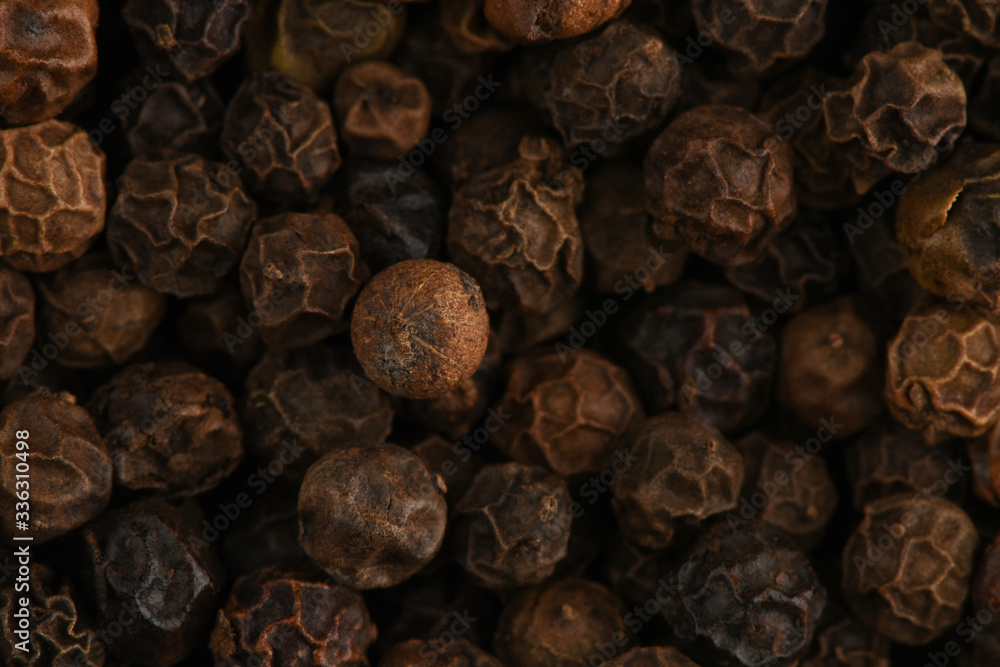 Black peppercorn super macro shot. Macro texture of black hot pepper. Macro spice background. Black peppercorn super macro shot. Macro texture of black hot pepper. Macro spice background.