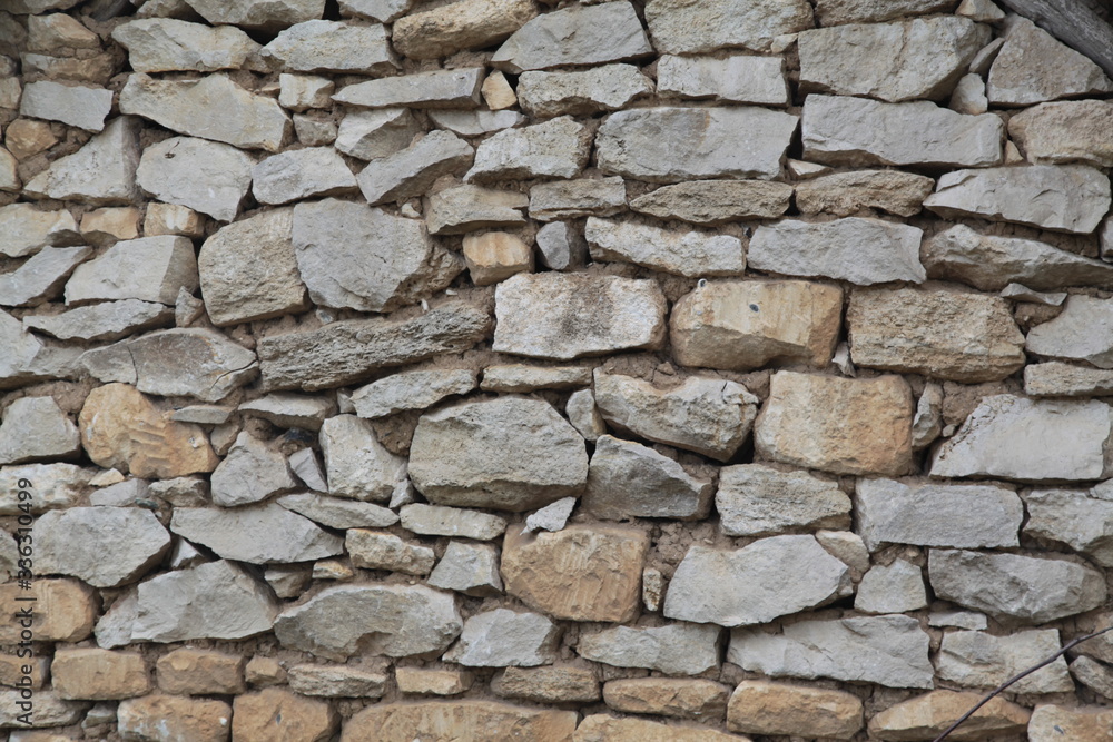 a wall made of stones. cobblestones with cement. masonry. construction