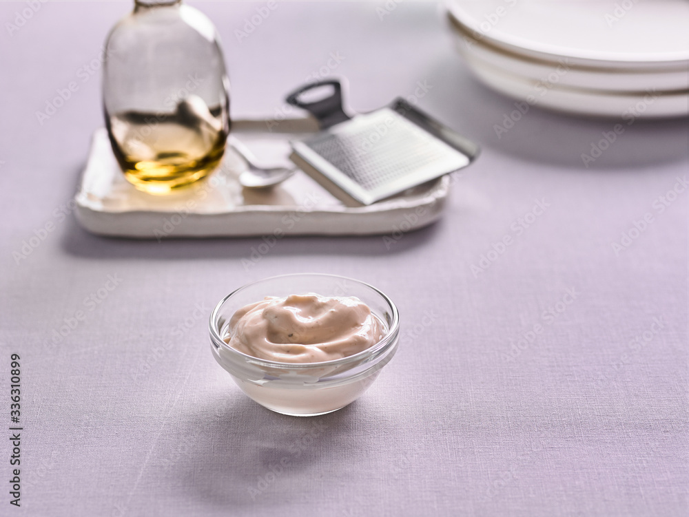 Caesar sauce in a bowl on the kitchen background Caesar sauce in a bowl on the kitchen background