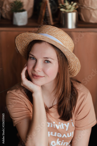 beautiful young girl with clean skin in a straw hat in quarantine at home © Yatsyna