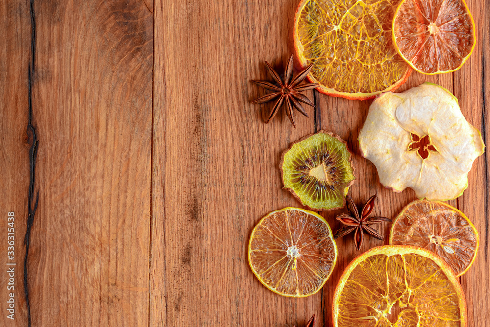 Dried orange, lemon, cinnamon sticks, anise star on rustic wooden background. Traditional mulled wine with spices. Dried orange, lemon, cinnamon sticks, anise star on rustic wooden background. Traditional mulled wine with spices.
