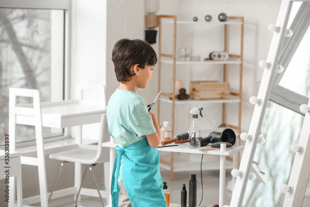 Cute little hairdresser in beauty salon Cute little hairdresser in beauty salon