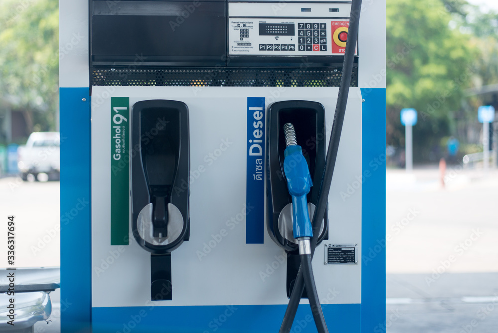Gas stations filling cars for cars during times of economic downturn and oil prices dropped significantly. Gas stations filling cars for cars during times of economic downturn and oil prices dropped significantly.