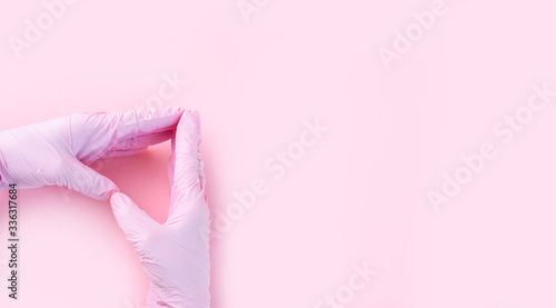 Wallpaper Mural Hands in medical gloves are pink in the shape of a heart on a pink background Torontodigital.ca