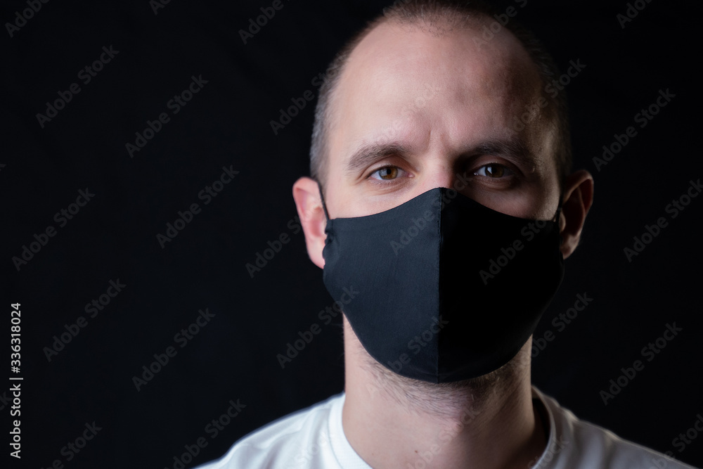 Man wearing black face mask. Pandemic coronavirus covid-19 quarantine period concept. Man wearing black face mask. Pandemic coronavirus covid-19 quarantine period concept.