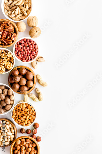 Set of macadamia, hazelnut, walnut, almond, pistachio, pecans nuts on white background top-down frame copy space