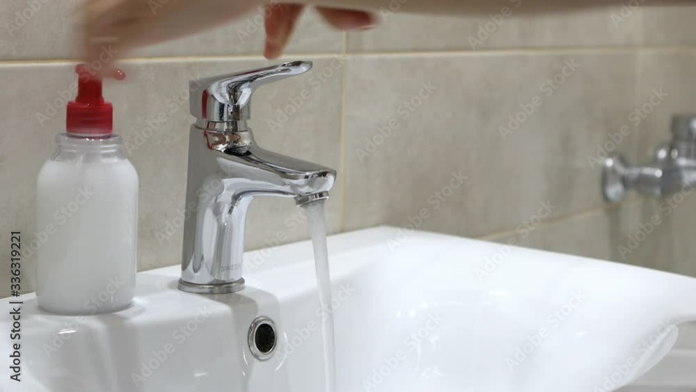 Woman washing her hands with soup to protect coronavirus pandemic Woman washing her hands with soup to protect coronavirus pandemic