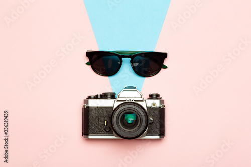 Photo camera creative concept background. Vintage retro photo camera on a colored background. Travel, vacation and photography concept