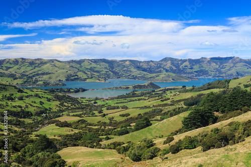 Fototapeta Naklejka Na Ścianę i Meble -  Banks Peninsula, New Zealand. A panoramic view of Akaroa Harbour (the town of Akaroa is to the right) from the surrounding hills