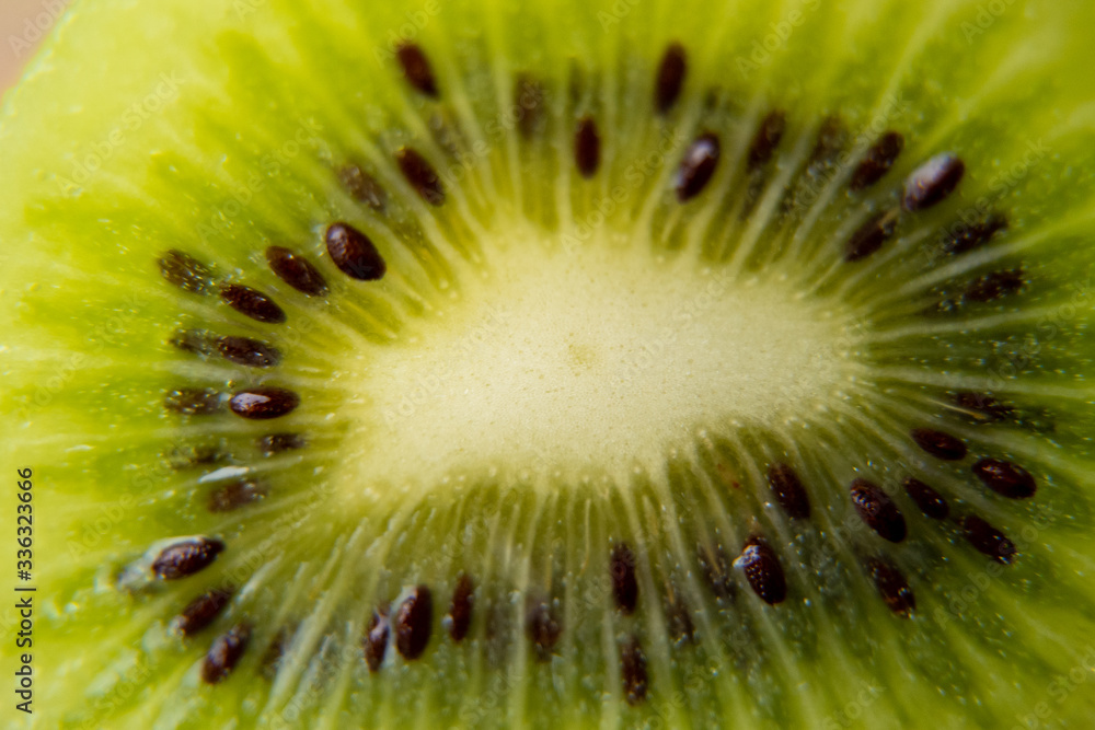 Close-up of slice of ripe kiwi. fruit gives off freshness and juice. fruit for diet and healthy food concept Close-up of slice of ripe kiwi. fruit gives off freshness and juice. fruit for diet and healthy food concept