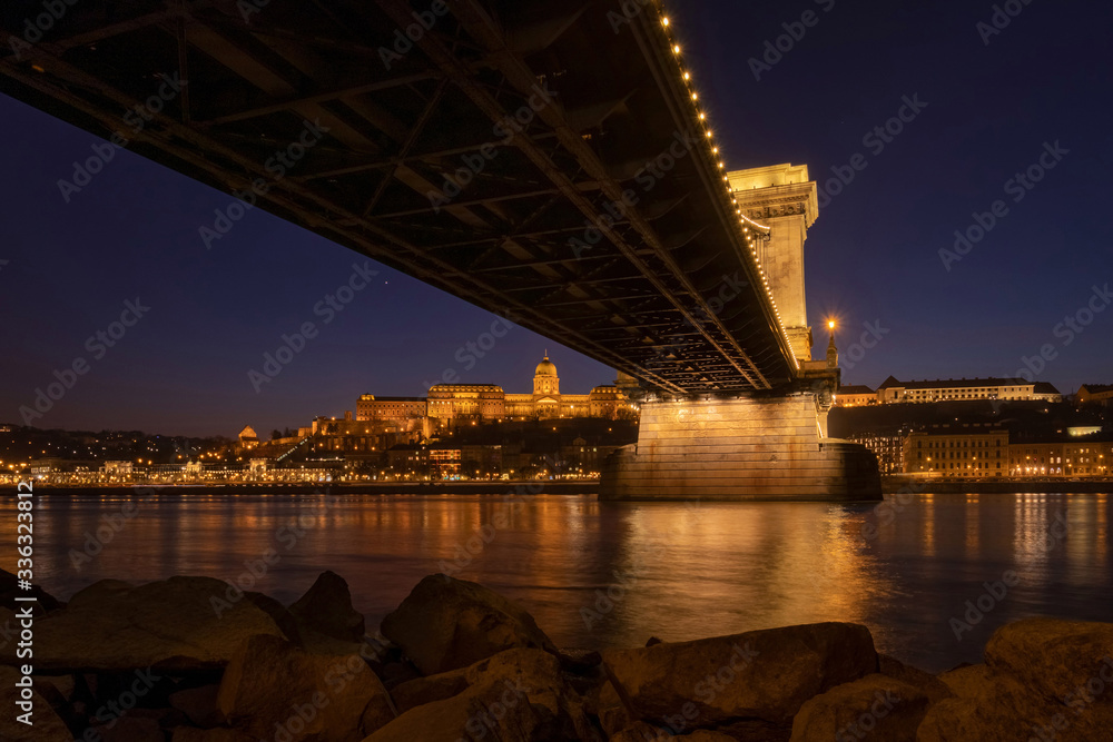 The Szechenyi Chain Bridge (Budapest, Hungary) with Buda Castle on the background at winter night
