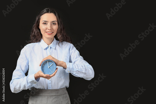 Businesswoman with alarm cl...