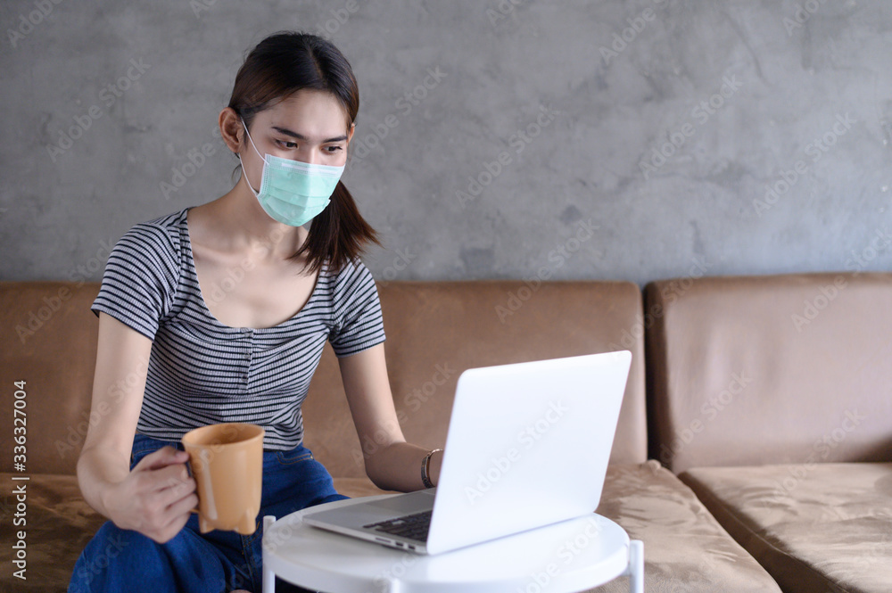 working from home during Coronavirus or Covid-19 outbreak, woman with face mask protection while working at home