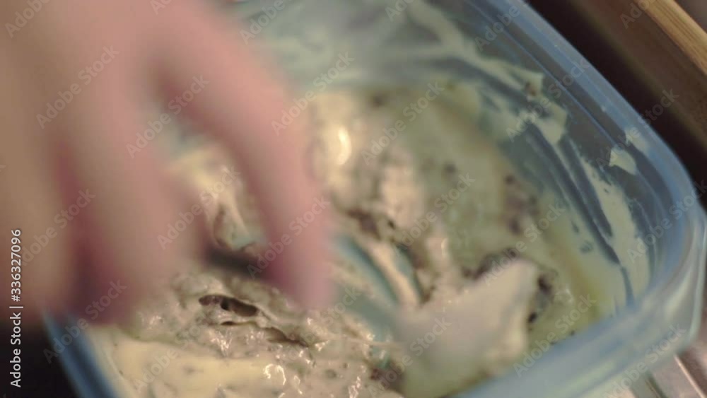 Mixing Cookie Pancake Batter In A Plastic Container With A Spoon - Closeup Shot