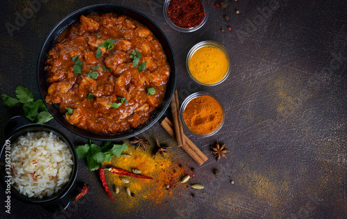 chicken curry with spices on a dark background photo