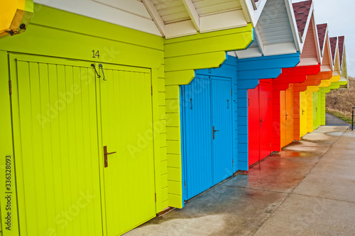 Row of colorful closed beach huts in seaside resort