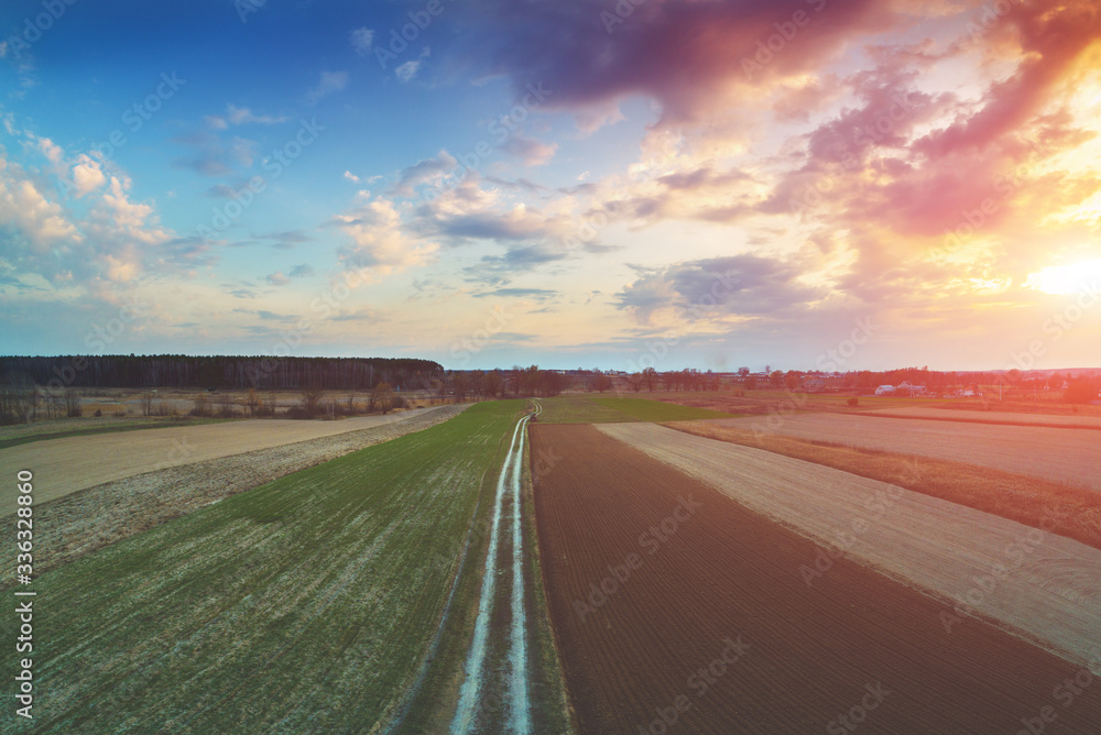 Sunset in countryside. Rural landscape in early spring. Aerial view