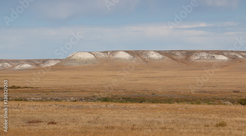 dry steppe, white hills on the horizon with white clay