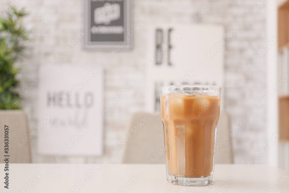 Glass of tasty iced coffee on table in cafe Glass of tasty iced coffee on table in cafe