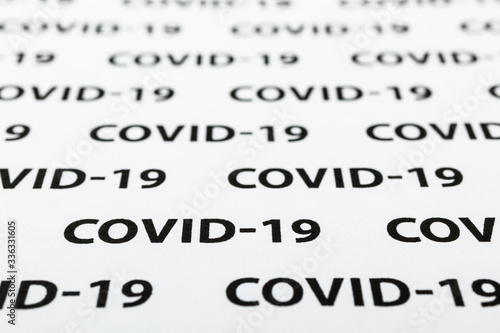 Black plain text on white paper about coronavirus outbreak. Covid-19.