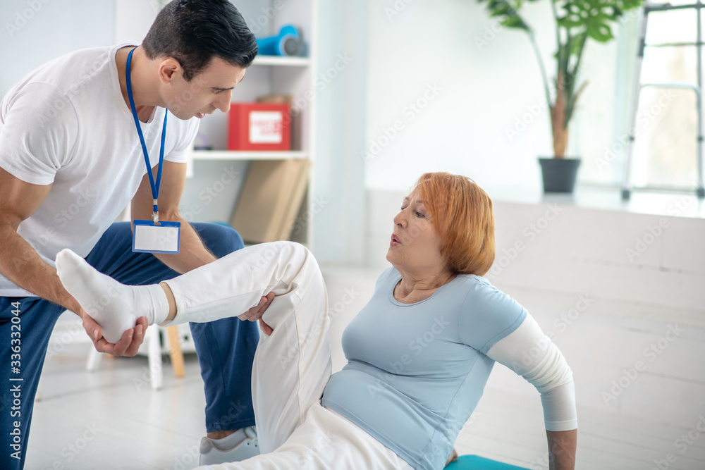 Fototapeta premium Active red haired woman doing a special physical exercise