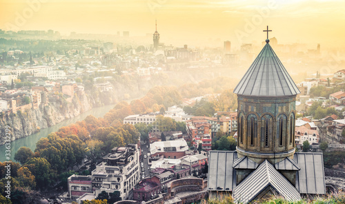 beautiful sunset view of Tbilisi and Saint Nicholas Church from Narikala Fortress, Georgia photo