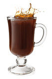Splashing of coffee in glass cup on white background