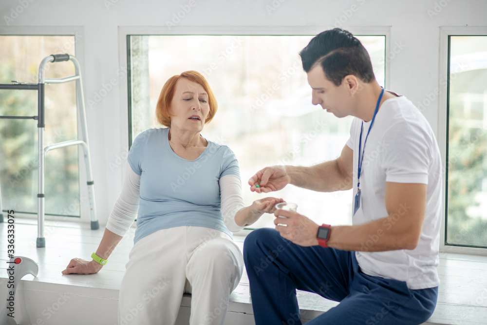 Nice red haired senior woman taking her pill Nice red haired senior woman taking her pill