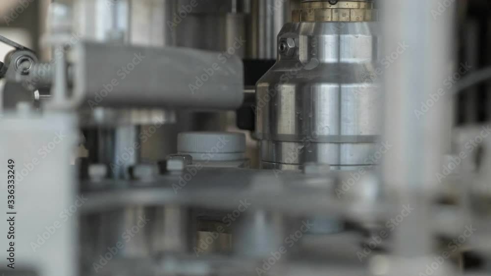 A metal part among many pipes. Spring fixed between nuts. Machine at the factory. Details close up. Motionless. A metal part among many pipes. Spring fixed between nuts. Machine at the factory. Details close up. Motionless.