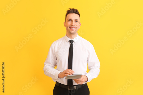 Young man with calculator o...