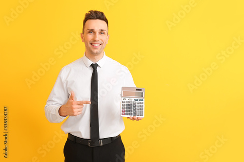 Young man with calculator o...