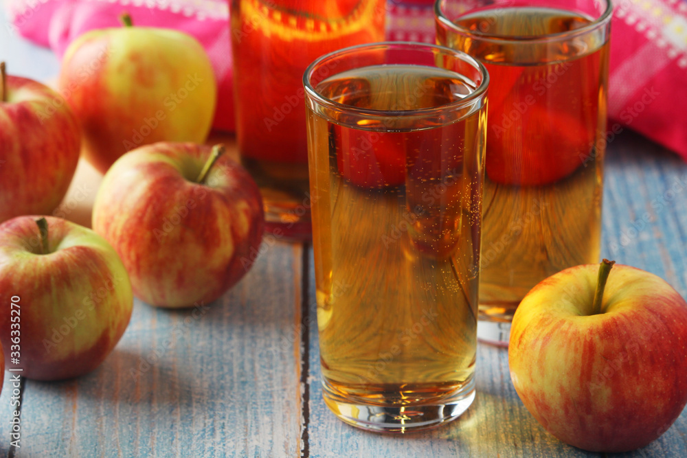 Glasses with apple juice and ripe apples Glasses with apple juice and ripe apples