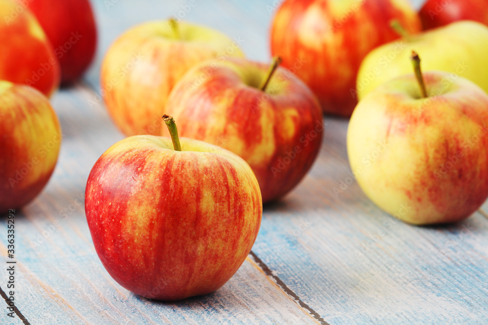 Several ripe red apples on the wooden table