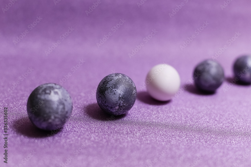 Eggs with marble stone effect painted with natural dye carcade flower on lilac sparkling background Eggs with marble stone effect painted with natural dye carcade flower on lilac sparkling background