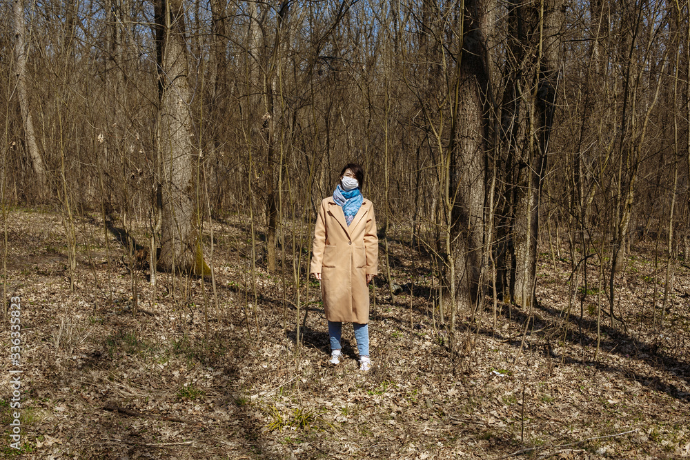 Self isolation. Masked walk in nature. Masked girl in the woods Self isolation. Masked walk in nature. Masked girl in the woods