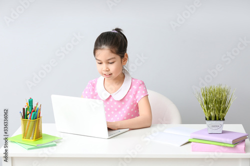 Little Asian girl doing hom...