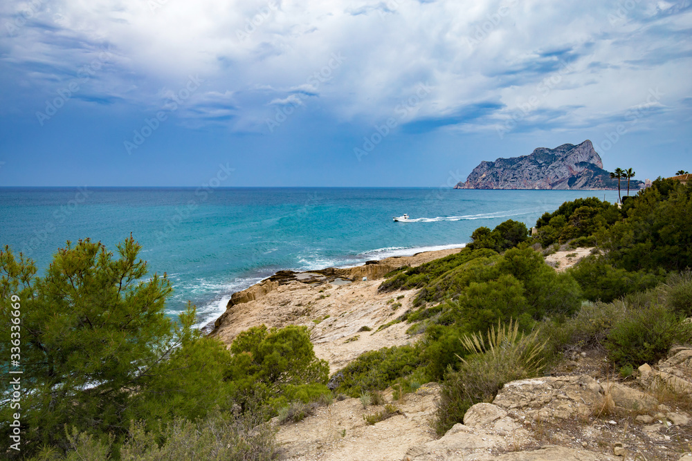 Fototapeta premium Panoramic view of the Ifach Rock Natural Park or Penon de Ifach in the city of Calpe in Spain. View from Moraira Costa Blanca.