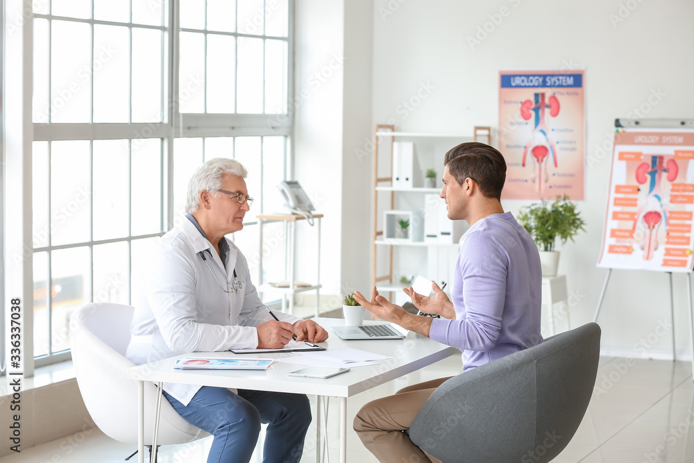 Young man visiting urologist in clinic Young man visiting urologist in clinic