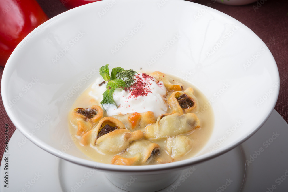 Bowl of fried dumpling served with sour cream Bowl of fried dumpling served with sour cream