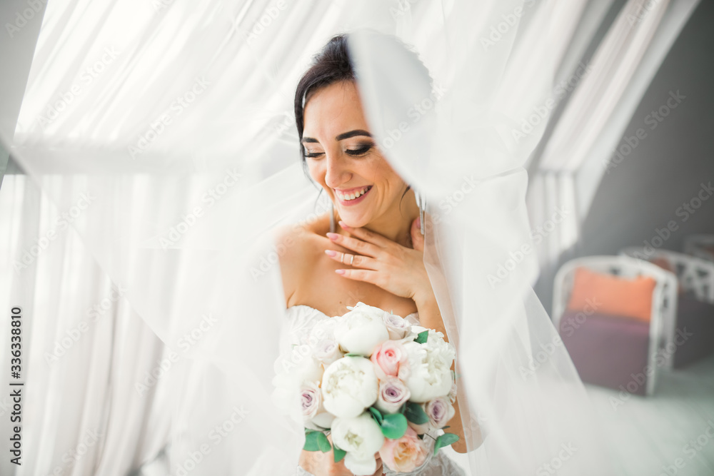 Portrait of stunning bride with long hair posing with great bouquet Portrait of stunning bride with long hair posing with great bouquet